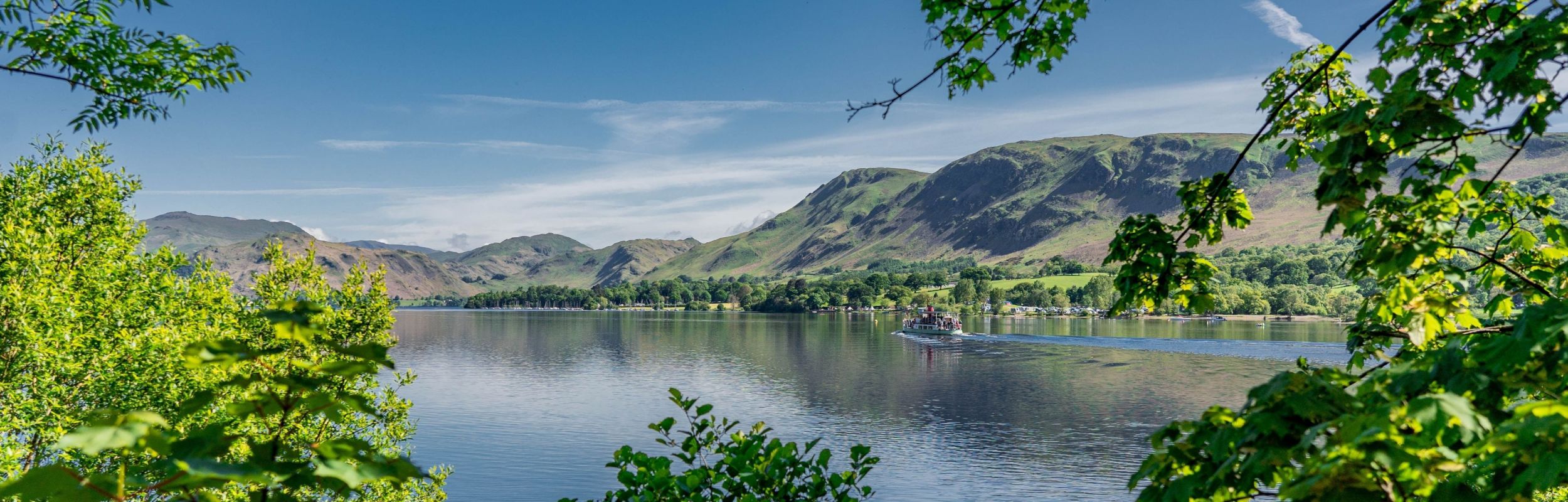 Panoramic view with a 'Steamer' sailing down Ullswater 
