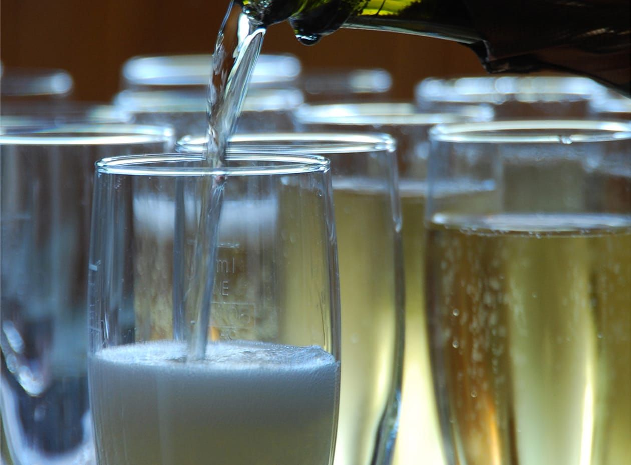 Prosecco being poured into a glasses for a wedding on Ullswater 'Steamers'
