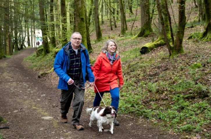 A couple and their dog walking up Dunmallard Hill